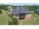 Brick home with screened porch, large backyard, and wooded area in background at 309 Marbella Way, Mcdonough, GA 30252