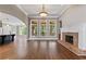 Bright living room with hardwood floors, fireplace, and access to screened porch at 309 Marbella Way, Mcdonough, GA 30252