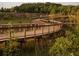 Wooden boardwalk path winding through a grassy marsh area at 628 Skytop Dr # 158, Cumming, GA 30040