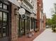 Storefronts in a charming shopping district with brick buildings and landscaping at 628 Skytop Dr # 158, Cumming, GA 30040