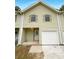 Light beige townhome with a white garage door at 1206 Pine Tree Trl # 12C, Atlanta, GA 30349