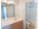 Clean bathroom with light wood vanity, tub and shower at 2986 Ashlyn Pointe Dr, Atlanta, GA 30340
