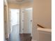 Upstairs hallway with doors to bedrooms and dark hardwood floors at 2986 Ashlyn Pointe Dr, Atlanta, GA 30340