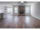 Open living room with hardwood floors and a brick fireplace at 1210 Red Oak Blvd, Loganville, GA 30052