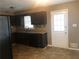 Galley kitchen with dark cabinets and granite countertops at 4410 Lamar Dr, Douglasville, GA 30134