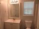 Updated bathroom with vanity, toilet, and mirror at 3475 Washington Rd, Atlanta, GA 30344