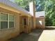 Brick house exterior with gray roof, wooden steps, and chimney at 3475 Washington Rd, Atlanta, GA 30344