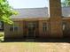Rear view of brick house with gray roof, wooden deck, and chimney at 3475 Washington Rd, Atlanta, GA 30344