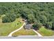 Aerial view of a house with a long driveway and surrounding woods at 3112 Highway 155 N, Mcdonough, GA 30252