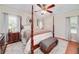 Spacious bedroom with a wooden post bed, hardwood floors, and ceiling fan at 3112 Highway 155 N, Mcdonough, GA 30252