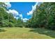 Open field with lush grass and bordering trees at 3112 Highway 155 N, Mcdonough, GA 30252