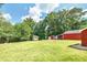 Spacious backyard with two storage sheds and mature trees at 3112 Highway 155 N, Mcdonough, GA 30252