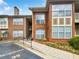 Brick building exterior with stairs and landscaping at 200 Renaissance Ne Pkwy # 302, Atlanta, GA 30308