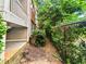 Private backyard with lush greenery and a chain link fence at 200 Renaissance Ne Pkwy # 302, Atlanta, GA 30308