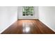 Bright living room featuring hardwood floors and large window at 200 Renaissance Ne Pkwy # 302, Atlanta, GA 30308