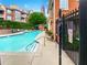 Community swimming pool with city views and surrounding foliage at 200 Renaissance Ne Pkwy # 302, Atlanta, GA 30308