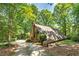 A-frame house with a wrap-around deck, nestled in a wooded lot at 3154 Highway 155 N, Mcdonough, GA 30252