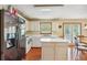 Bright kitchen features an island, white cabinets, and access to the backyard at 9334 Woodsboro Ct, Jonesboro, GA 30236