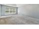 Spacious bedroom with neutral gray walls and gray carpeting at 9334 Woodsboro Ct, Jonesboro, GA 30236