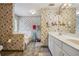 Bathroom with double vanity, shower, and floral wallpaper at 9334 Woodsboro Ct, Jonesboro, GA 30236