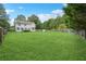 Large backyard with grassy area, deck, and fenced perimeter at 9334 Woodsboro Ct, Jonesboro, GA 30236