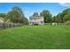 Spacious backyard with green lawn and home view at 9334 Woodsboro Ct, Jonesboro, GA 30236
