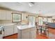 Open kitchen with island, white cabinets, and views of living areas at 9334 Woodsboro Ct, Jonesboro, GA 30236
