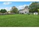 Spacious backyard featuring a large grassy area, deck, and playset at 9334 Woodsboro Ct, Jonesboro, GA 30236