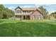 Two-story brick and vinyl home with green lawn at 9334 Woodsboro Ct, Jonesboro, GA 30236