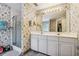 Bathroom with double vanity, shower, and floral wallpaper at 9334 Woodsboro Ct, Jonesboro, GA 30236