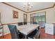 Formal dining room with marble table and view of the living room at 9334 Woodsboro Ct, Jonesboro, GA 30236