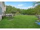 Large backyard with deck and green lawn at 9334 Woodsboro Ct, Jonesboro, GA 30236