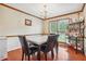 Elegant dining room with hardwood floors, marble table, and chandelier at 9334 Woodsboro Ct, Jonesboro, GA 30236