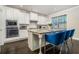 Modern kitchen with white cabinets, granite countertops, and stainless steel appliances at 1068 W Union Grove Cir, Auburn, GA 30011