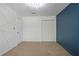 Bedroom with white and blue walls and double-door closet at 6584 Sleepy Hollow Ln, Morrow, GA 30260