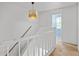 Upstairs hallway with carpet, light fixture, and access to bedrooms at 6584 Sleepy Hollow Ln, Morrow, GA 30260