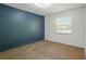 Bedroom with blue accent wall and neutral carpeting at 6584 Sleepy Hollow Ln, Morrow, GA 30260