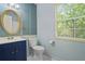 Bathroom with navy vanity and gold mirror at 6584 Sleepy Hollow Ln, Morrow, GA 30260