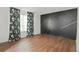 Bright living room with hardwood floors and an accent wall at 6584 Sleepy Hollow Ln, Morrow, GA 30260