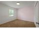Bright bedroom with neutral walls and carpet at 6584 Sleepy Hollow Ln, Morrow, GA 30260