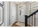 Bright entryway with a white door, hardwood floors, and a staircase at 1062 Kirkland Cir, Smyrna, GA 30080