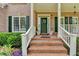 Brick front porch with white railings at 4797 Cedar Wood Sw Dr, Lilburn, GA 30047