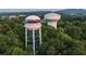 Aerial view of Cumming, GA, featuring water towers and lush green trees at 615 Skytop Dr, Cumming, GA 30040