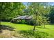Ranch style home with side yard and mature trees at 725 Holland Rd, Powder Springs, GA 30127