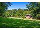 Spacious backyard with lush lawn and wooded backdrop at 725 Holland Rd, Powder Springs, GA 30127