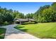 House with carport, long driveway, and expansive lawn at 725 Holland Rd, Powder Springs, GA 30127