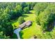 Home surrounded by lush trees and a large yard at 725 Holland Rd, Powder Springs, GA 30127