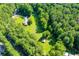 Property showcasing house, outbuildings, and surrounding woods at 725 Holland Rd, Powder Springs, GA 30127