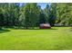 Red barn in a large, grassy field at 725 Holland Rd, Powder Springs, GA 30127