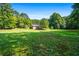 Large backyard with green lawn, providing privacy at 725 Holland Rd, Powder Springs, GA 30127